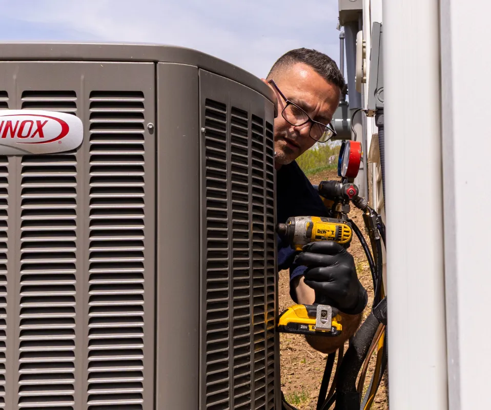 A Sila Technician repairing an AC Unit