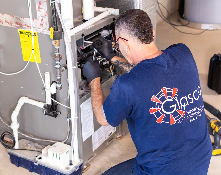A Sila technician repairing a furnace